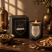 Atelier Candela Santal Cardamom 14 oz artisanal soy candle beside its black and gold gift box